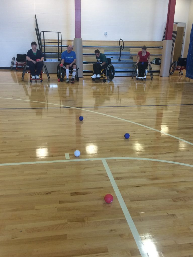 group playing adaptive boccia ball in gym